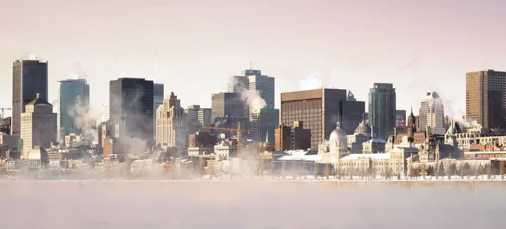 Montreal skyline with winter mist rising from the St. Lawrence River showcasing the city's modern towers