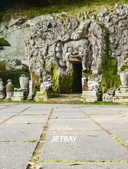 Ancient stone temple entrance with intricate carvings and moss-covered architecture in Mumbai, India