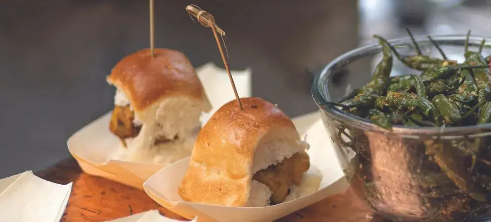 Gourmet sliders and roasted peppers showcasing Mumbai's upscale dining scene for luxury travelers