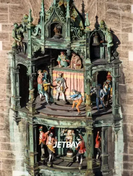 Historic Glockenspiel clock tower in Munich's Marienplatz featuring colorful dancing figures and bells