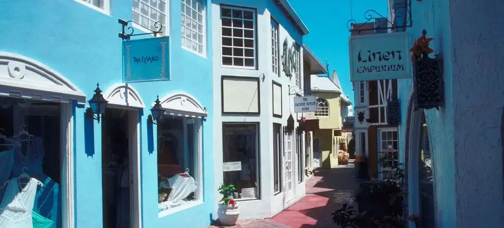 Colorful colonial storefronts line a charming Nassau street showcasing Bahamian architecture and culture