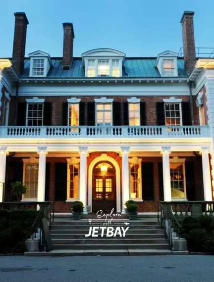 Elegant colonial mansion with illuminated windows and grand entrance steps in historic Nassau, Bahamas