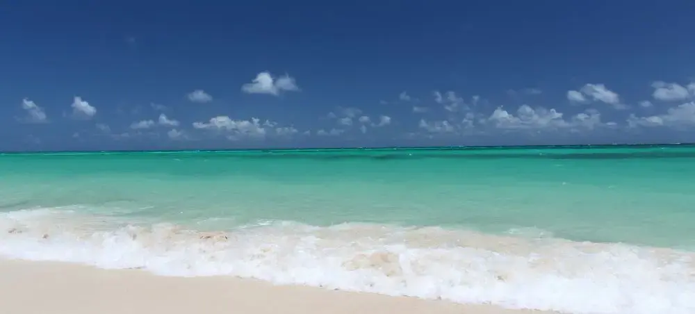 Pristine white sand beach with turquoise waters in Nassau, Bahamas showcasing tropical paradise destination