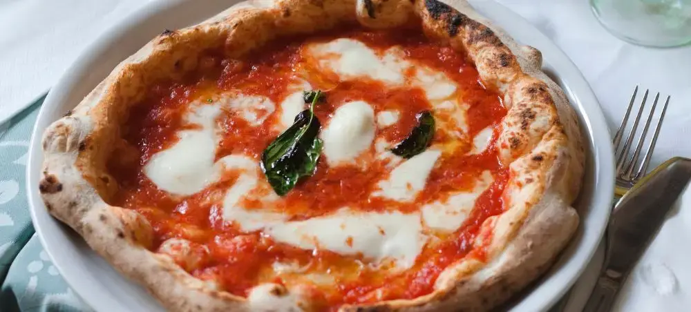Authentic Neapolitan pizza margherita with fresh mozzarella and basil showcasing Italy's culinary heritage