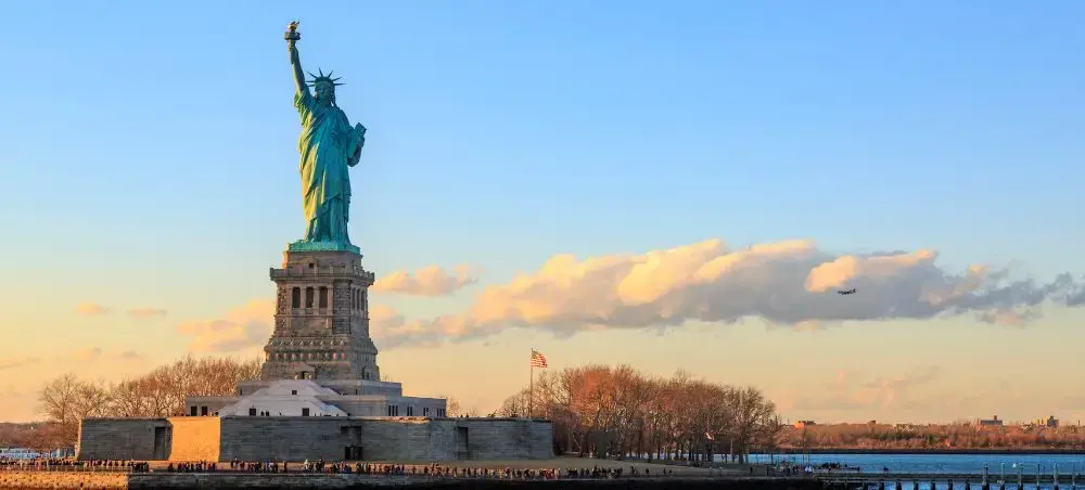 Statue of Liberty at golden hour showcasing New York's iconic landmark for luxury private jet travelers