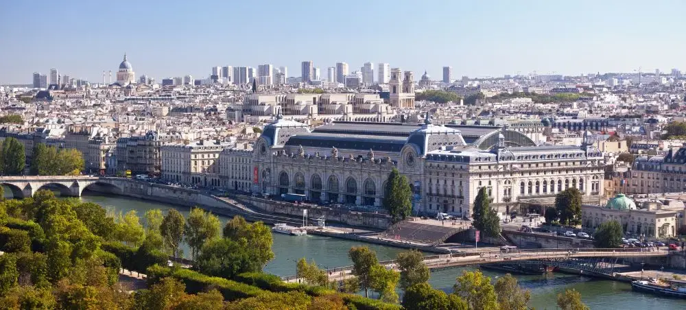Panoramic view of Paris skyline with Seine River, historic architecture and modern buildings for luxury travel