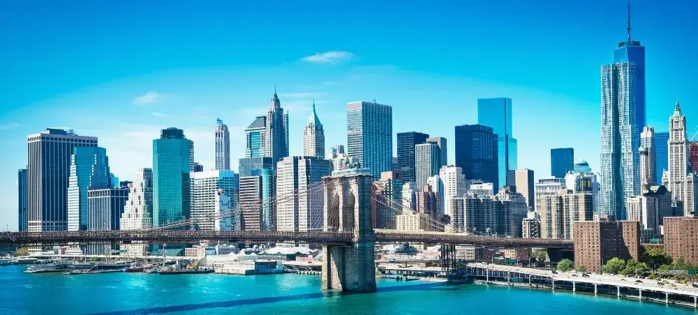 Manhattan skyline featuring Brooklyn Bridge and One World Trade Center for luxury private jet travel to NYC