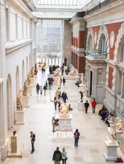Metropolitan Museum of Art's grand hall showcasing classical sculptures and architecture in New York City