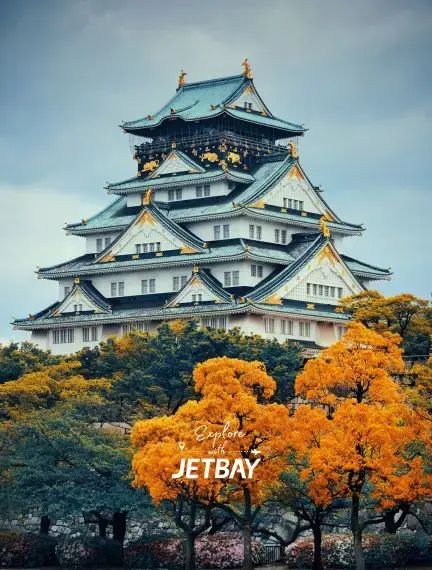 Osaka Castle's iconic multi-tiered architecture surrounded by vibrant autumn foliage in Japan