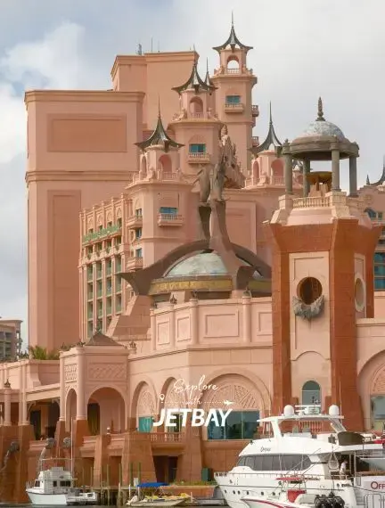 Atlantis Paradise Island resort's distinctive pink architecture and marina with luxury yachts in Nassau