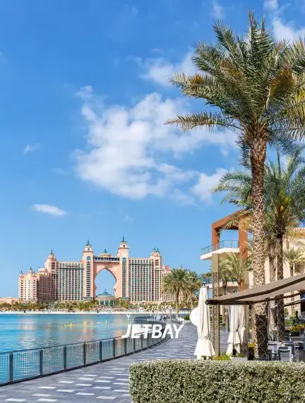 Atlantis Paradise Island resort viewed from waterfront terrace with palm trees in Nassau, Bahamas