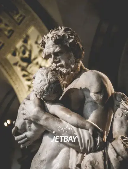 Classical marble sculpture depicting embracing figures in ornate Parisian museum showcasing the city's artistic heritage