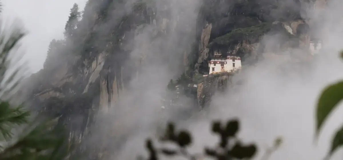 Mystical Himalayan monastery perched on misty clifftop in Paro, Bhutan showcasing dramatic mountain scenery