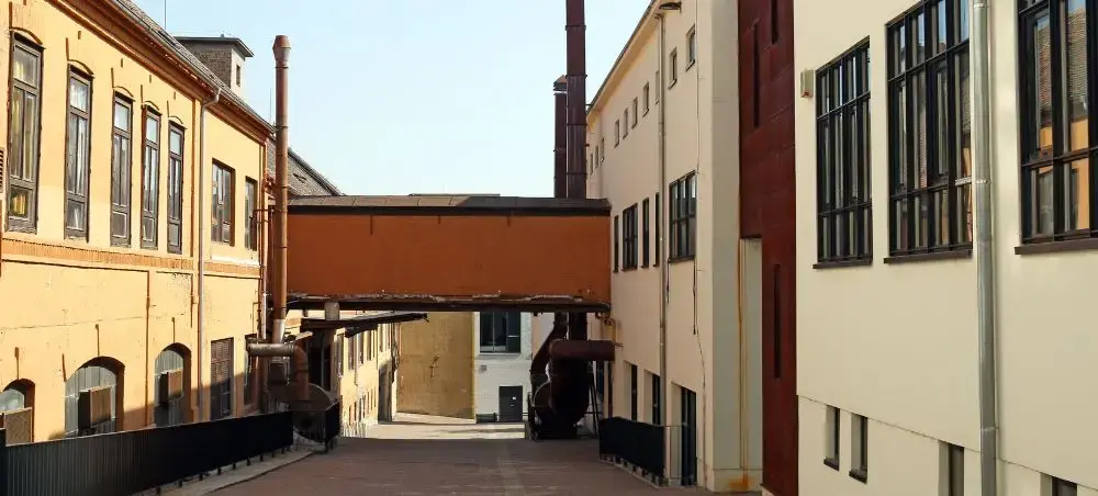 Historic industrial buildings and walkway in Pecs Hungary showcasing the city's architectural heritage