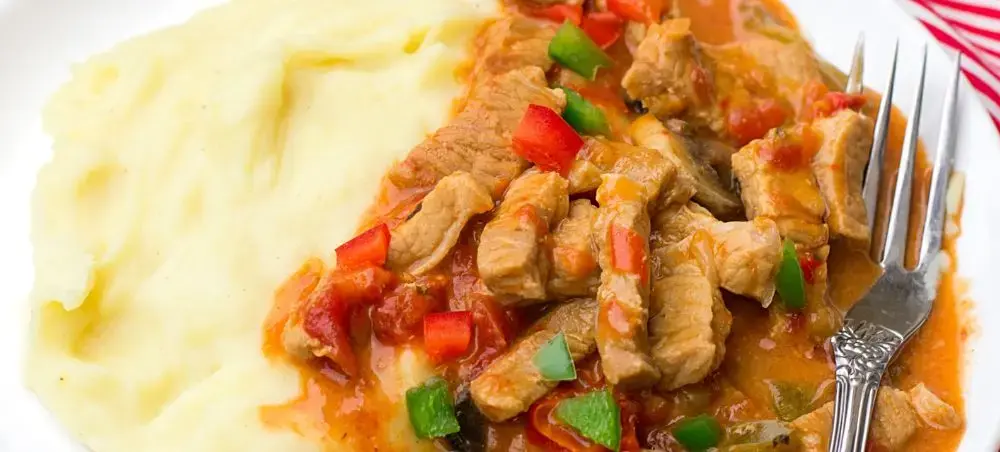 Traditional Hungarian goulash with tender beef and creamy mashed potatoes showcasing Pecs culinary heritage
