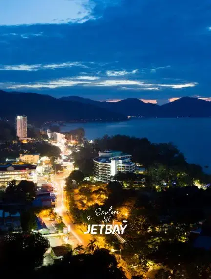Penang cityscape at twilight with illuminated streets and harbor views showcasing Malaysia's vibrant coastal destination