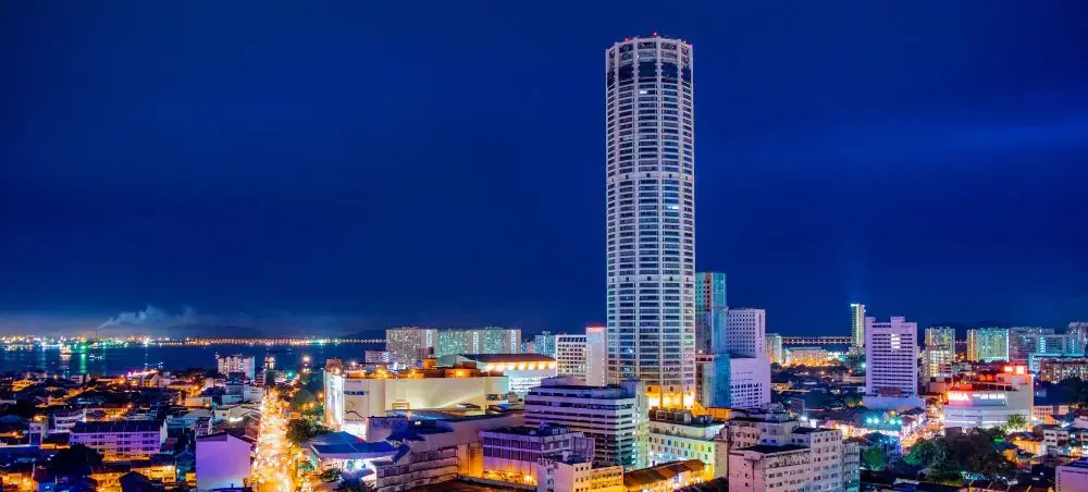 Penang skyline at dusk showcasing illuminated skyscrapers and waterfront views for luxury travel
