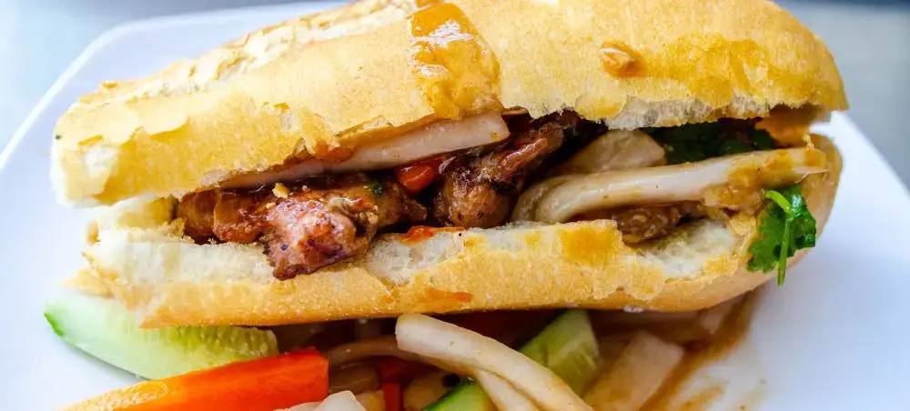 Authentic Cambodian sandwich with grilled meat and fresh vegetables served during luxury travel to Phnom Penh