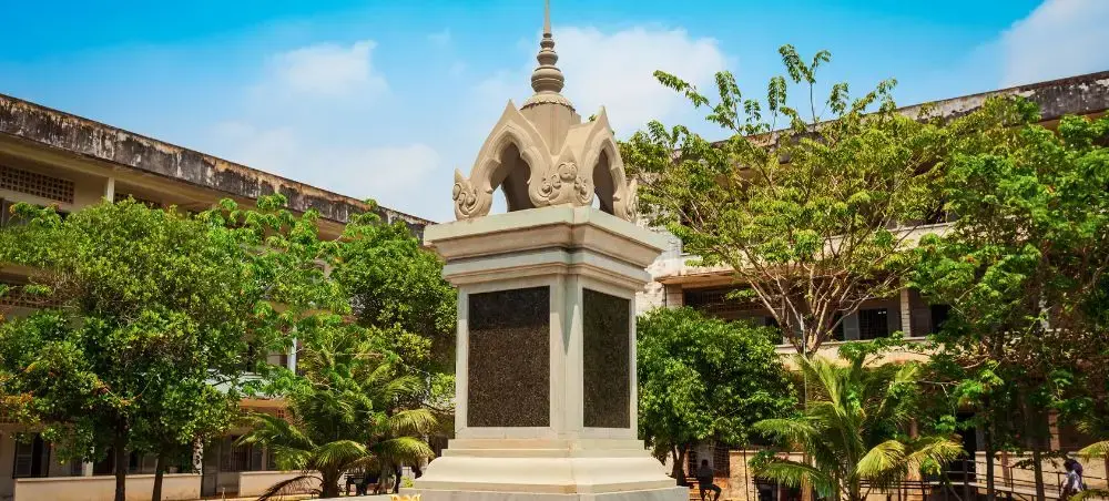 Traditional Khmer monument with ornate spire surrounded by lush tropical gardens in Phnom Penh Cambodia