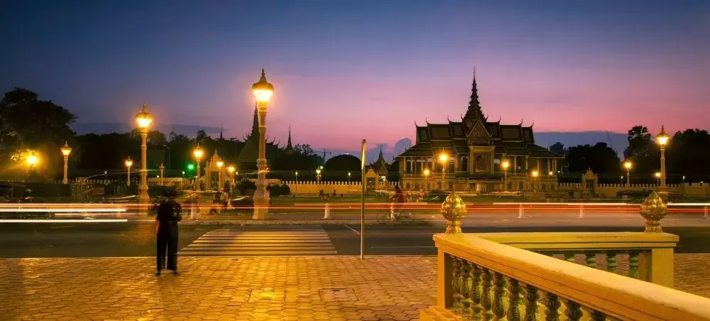 Royal Palace illuminated at twilight in Phnom Penh, showcasing Cambodia's architectural heritage