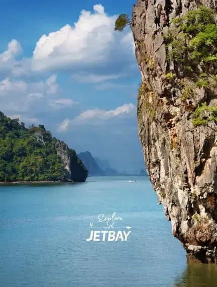 Dramatic limestone cliffs rising from turquoise waters in Phuket's stunning tropical archipelago