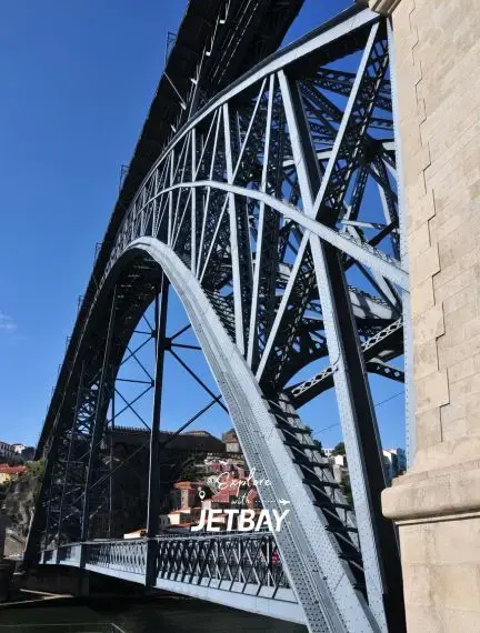 Historic Dom Luís I Bridge spanning the Douro River in Porto with steel arches and stone pillars