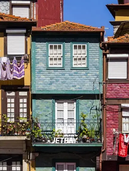 Colorful traditional Portuguese houses with ornate balconies in Porto's historic Ribeira district