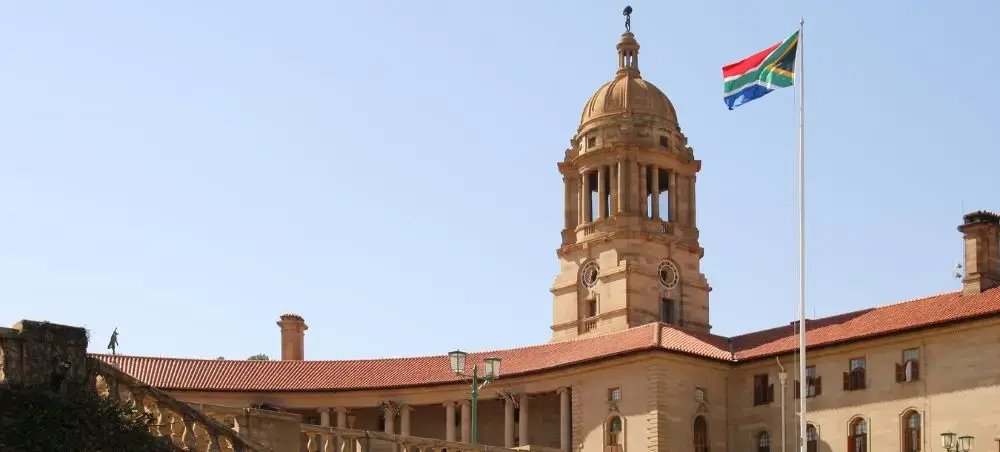 Historic Union Buildings in Pretoria with South African flag, showcasing the capital's government architecture