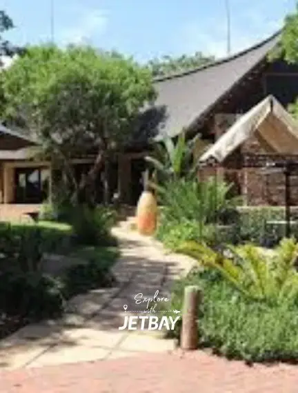 Luxury safari lodge with thatched roofs and lush gardens in Pretoria, South Africa destination