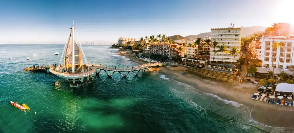 Aerial view of Puerto Vallarta's iconic pier and luxury beachfront resorts along Mexico's Pacific coast