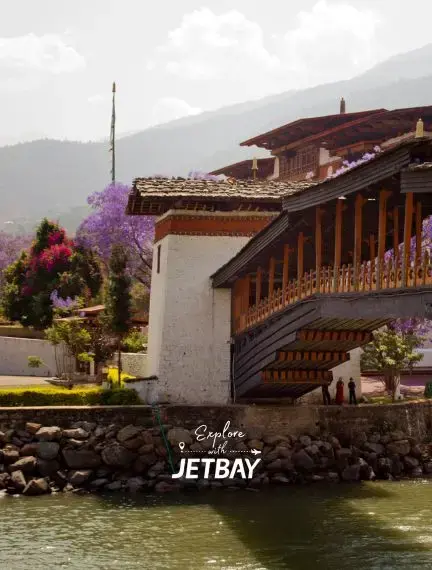 Traditional Bhutanese architecture with wooden balconies overlooking river in Punakha valley