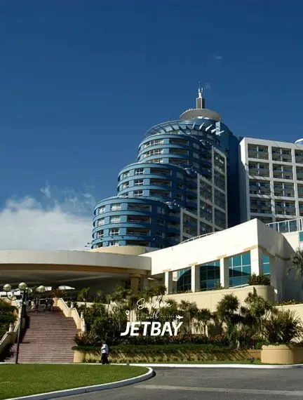 Modern luxury resort architecture with curved glass towers and Jetbay branding in Punta del Este, Uruguay