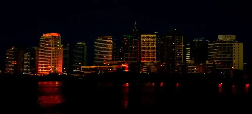Punta del Este waterfront skyline illuminated at night with luxury high-rise buildings reflecting in calm waters