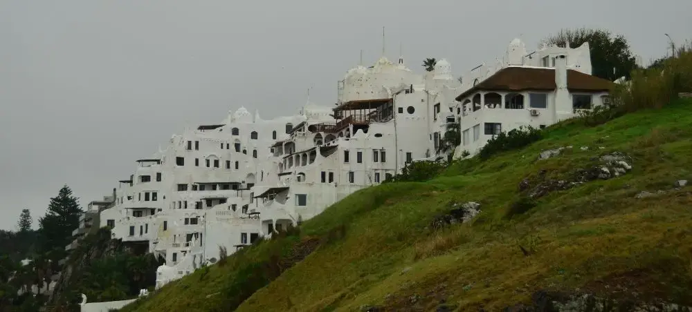 Distinctive white hillside architecture cascading down green slopes in Punta del Este, Uruguay