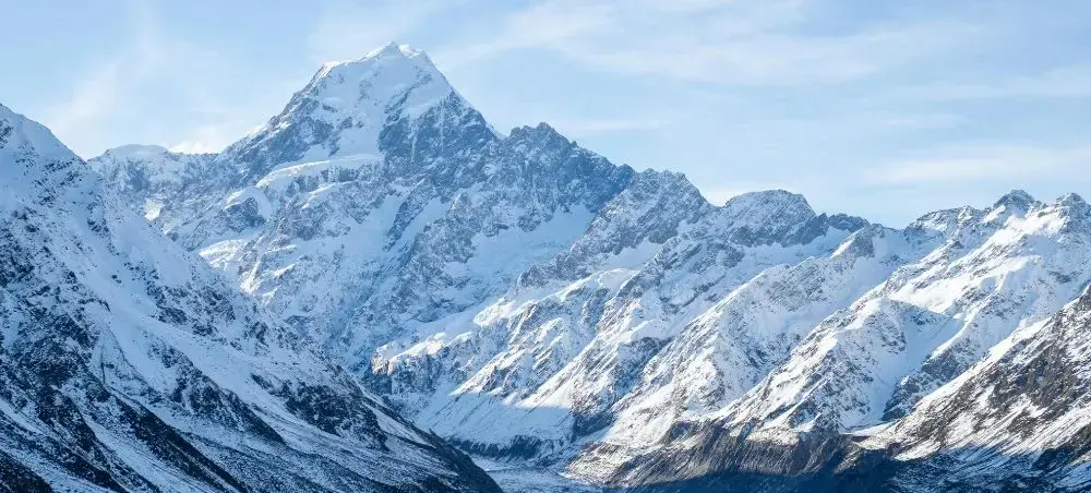 Snow-capped Southern Alps mountain range surrounding Queenstown showcasing New Zealand's dramatic alpine scenery