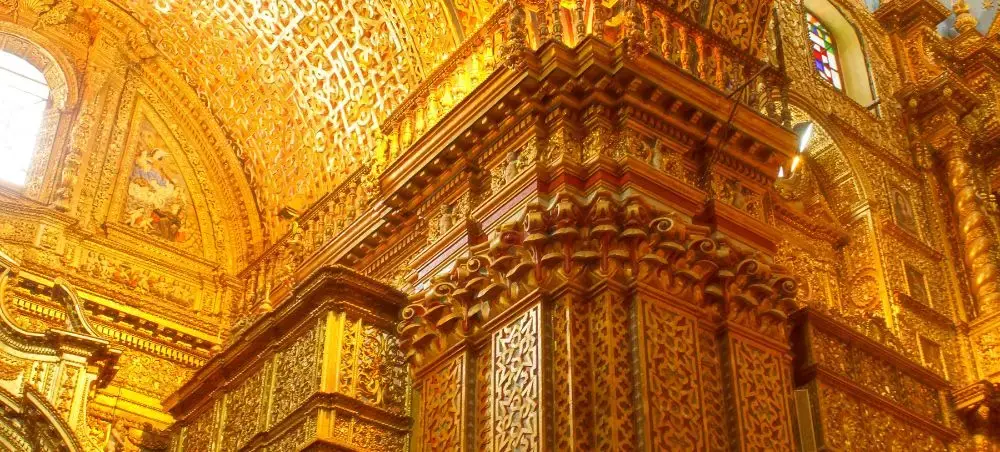 Ornate golden baroque interior of La Compañía de Jesús church showcasing Quito's colonial heritage