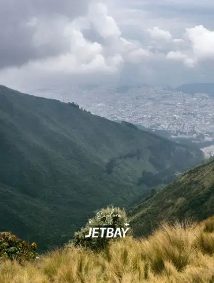 Panoramic view of Quito cityscape from Andean mountainside with Jetbay branding for luxury travel
