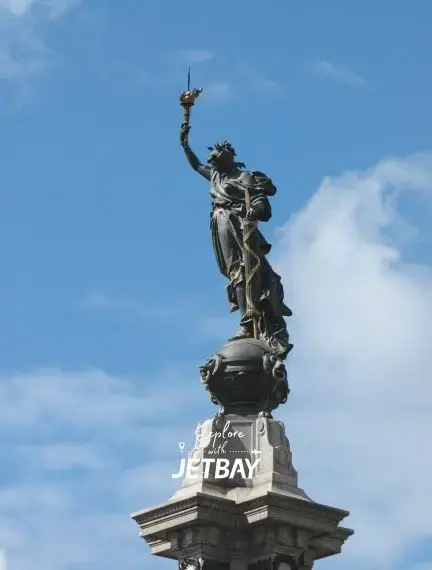 Winged Victory monument towering against blue sky in historic Quito, Ecuador's capital city