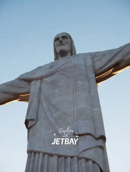 Christ the Redeemer statue illuminated at dusk overlooking Rio de Janeiro, Brazil's iconic landmark