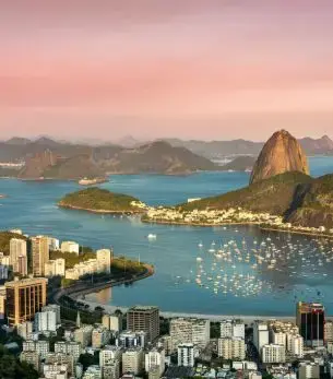 Sugarloaf Mountain and Guanabara Bay at sunset showcasing Rio de Janeiro's iconic coastline and luxury travel destination