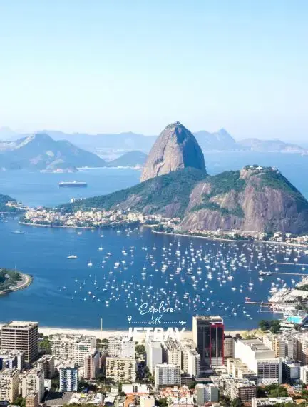 Aerial view of Rio de Janeiro showcasing Sugarloaf Mountain, Guanabara Bay, and luxury yacht marina