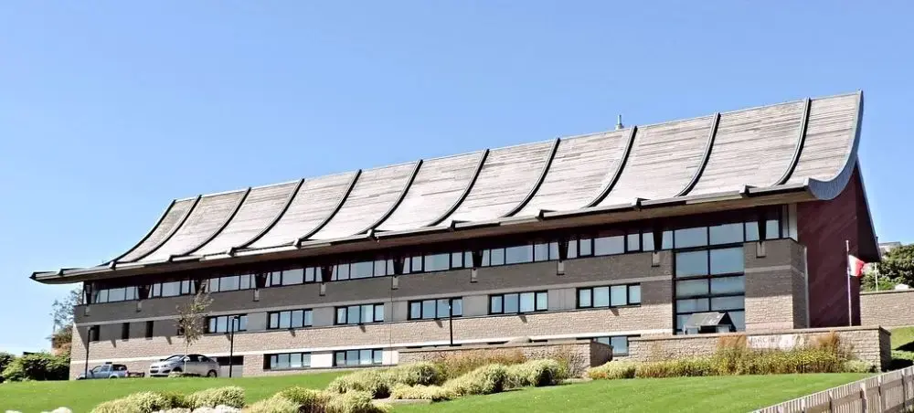 Modern government building with distinctive curved metal roof in Saint Pierre showcasing local architecture