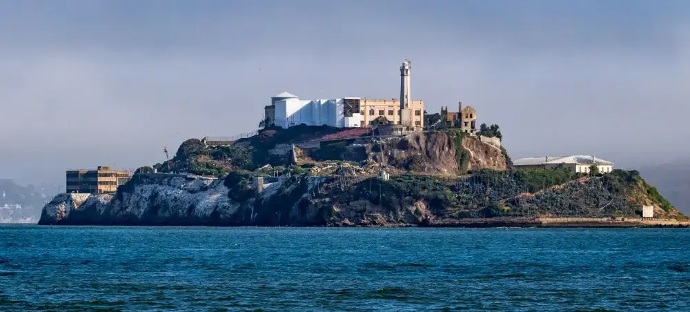 Alcatraz Island prison complex rising from San Francisco Bay waters, showcasing iconic destination for luxury travel