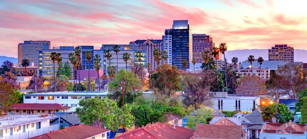 San Jose Costa Rica downtown skyline at sunset with modern buildings and palm trees illuminated