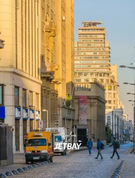 Golden hour sunlight illuminates historic Santiago streets with colonial architecture and modern towers