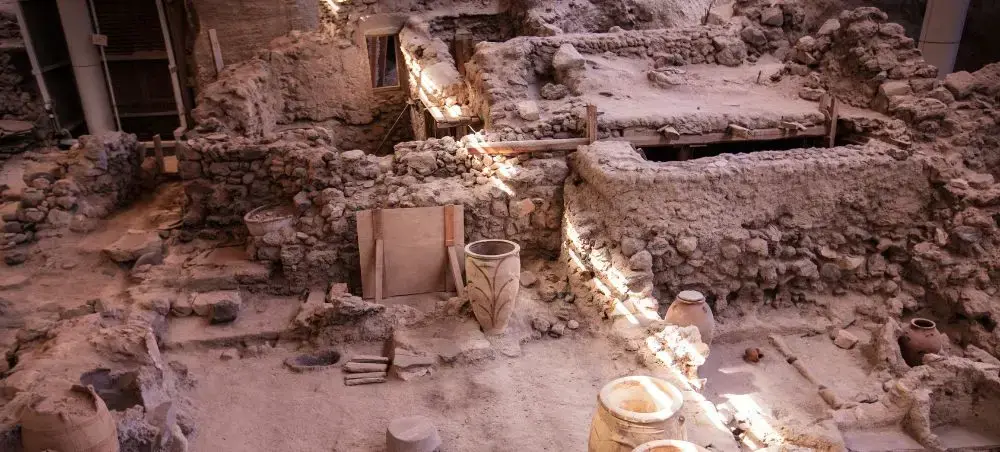 Ancient Minoan archaeological excavation site in Santorini showcasing preserved stone structures and artifacts