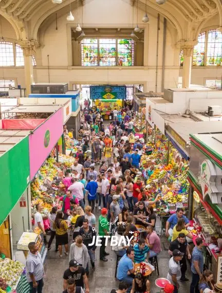 Bustling Mercado Municipal in São Paulo with crowds shopping for fresh produce under historic arched ceiling