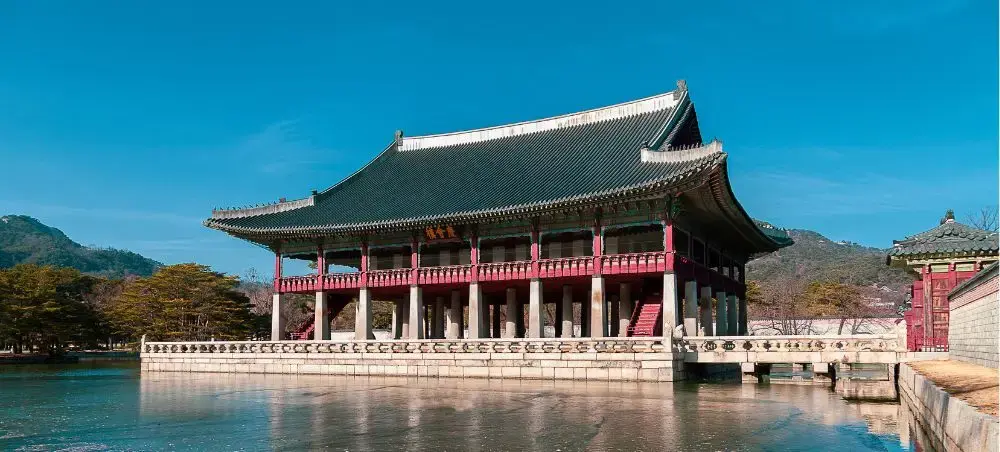 Traditional Korean pavilion reflecting in tranquil waters at Gyeonghoeru in Seoul's Gyeongbokgung Palace