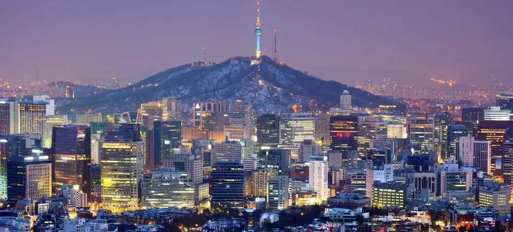 Seoul skyline at twilight with illuminated skyscrapers and N Seoul Tower atop Namsan Mountain