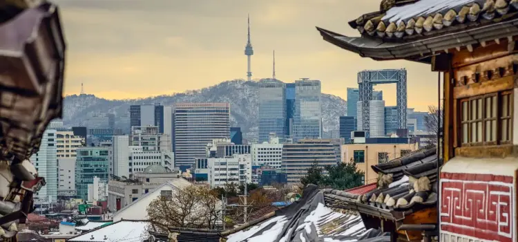 Seoul skyline with N Seoul Tower viewed through traditional Korean hanok architecture rooftops
